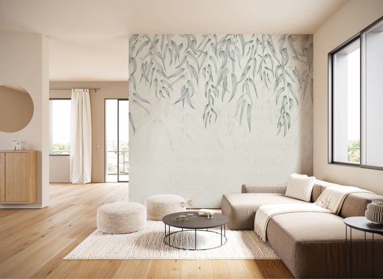 Heller Wohnraum mit Sofa, Teppich und Wandtapete mit Pflanzenmotiven