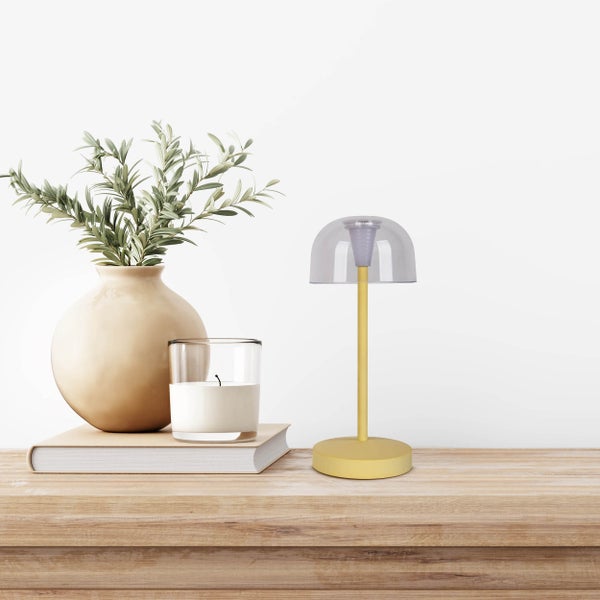 Dekorative Szene mit Vase, Kerze und Tischleuchte auf einem Buch