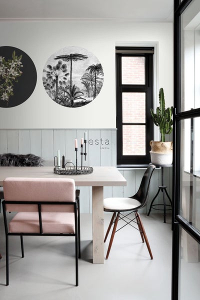 Esszimmer mit Esstisch, Stühlen, Wanddekoration und Kaktus im Topf