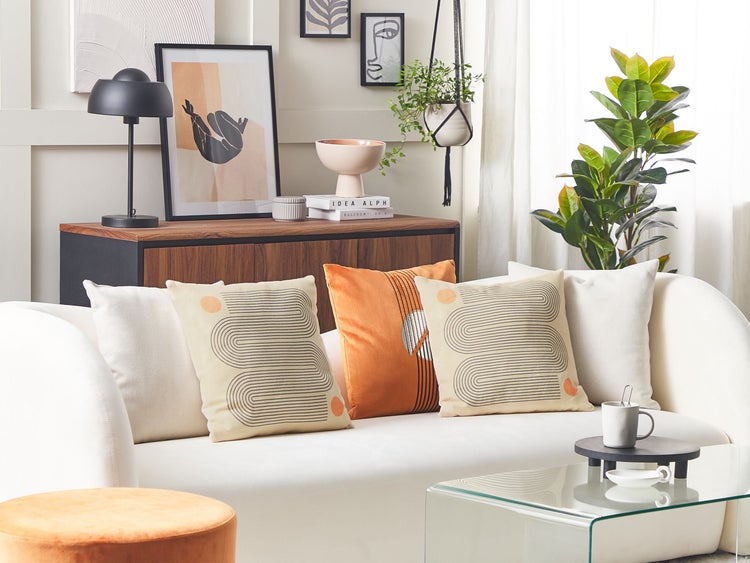 Wohnzimmer mit Sofa, Kissen, Tisch und dekorativen Elementen für ein gemütliches Ambiente