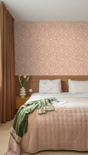 Schlafzimmer mit gemusterter Tapete, Bett und Vorhängen