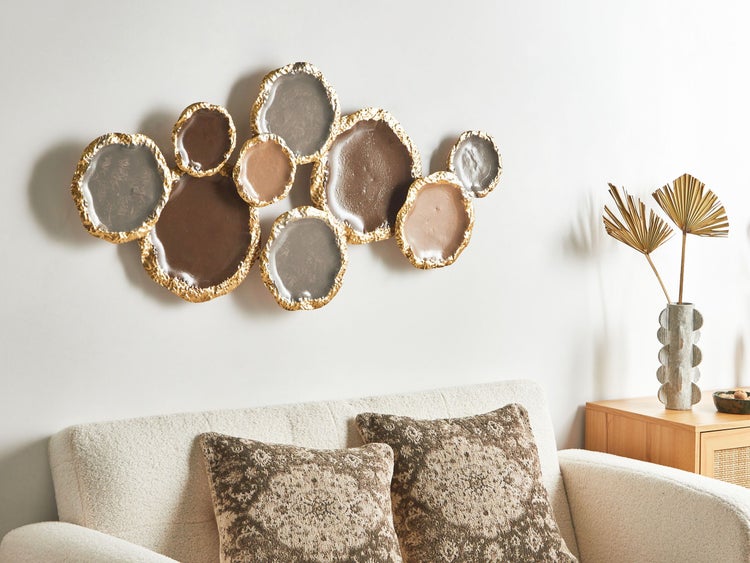 Wanddekoration aus runden Elementen mit goldfarbenen Rändern