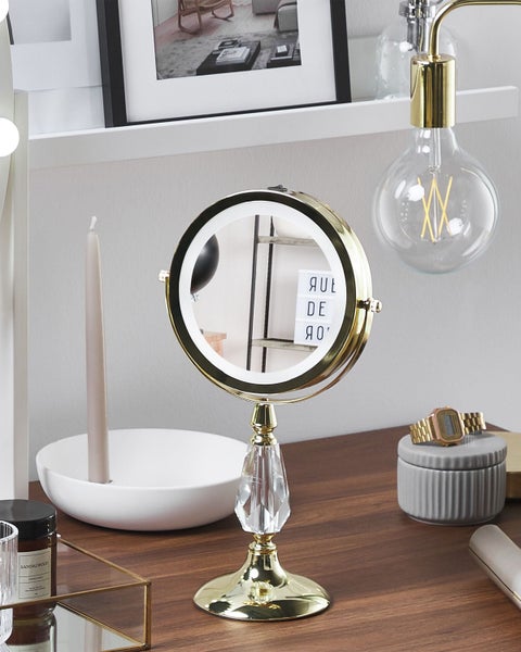 Goldener Kosmetikspiegel mit LED-Beleuchtung auf einem Schminktisch