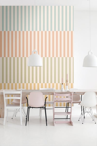 Helle, freundliche Essecke mit gestreifter Tapete, Esstisch und verschiedenen Stühlen