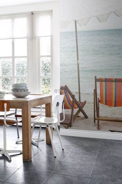 Esszimmer mit Holztisch, Stühlen und Fototapete mit Strandmotiv