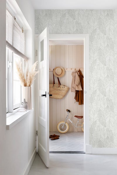 Flur mit Blattmuster-Tapete, Dekorationen und Kinderfahrrad