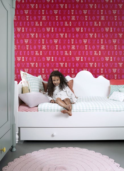 Kinderzimmer mit roter Tapete, weißem Bett und Mädchen