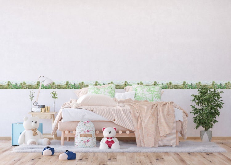 Kinderzimmer mit Dinosaurier-Bordüre, Bett und Spielzeug