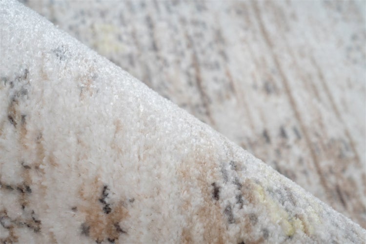 Nahaufnahme eines weichen Hochflor-Teppichs mit abstraktem Muster.