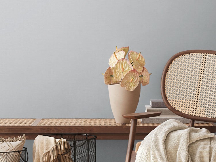 Schlafzimmer mit geometrischer Tapete, Bett und Nachttischlampe