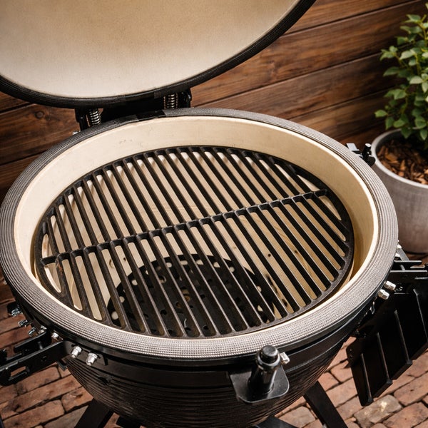 Keramikgrill mit Grillrost und geöffnetem Deckel.