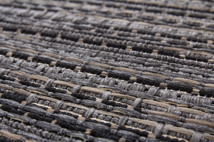 Nahaufnahme eines gewebten Teppichs mit strukturierter Oberfläche.