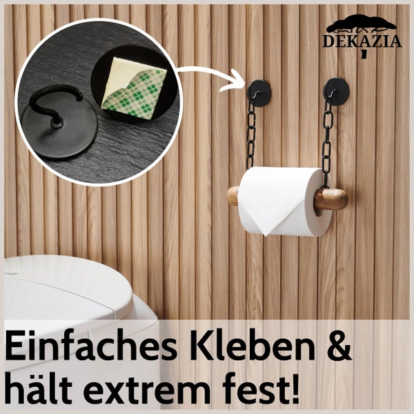 Dekazia Logo. Selbstklebender Toilettenpapierhalter mit schwarzer Kette und Holzstab an einer Holzwand sowie Detailansicht des Klebepads.