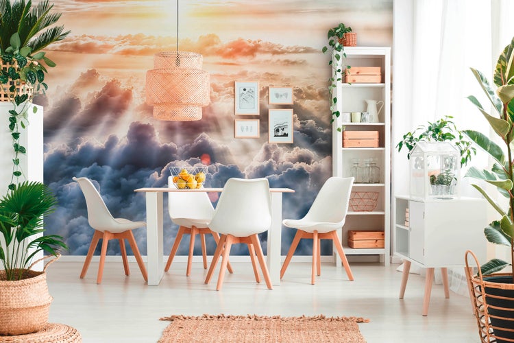 Modernes Esszimmer mit Fototapete eines Himmels mit Wolken, weißem Tisch, vier weißen Stühlen, Rattan-Pendelleuchte und vielen Zimmerpflanzen.