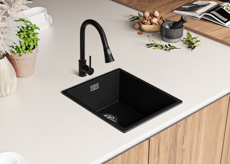 Schwarze Küchenspüle mit Wasserhahn auf einer Küchentheke