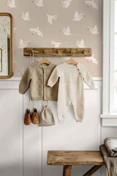 Tapete mit Schwanenmuster in einem Kinderzimmer mit einer Holzgarderobe an einer holzvertäfelten Wand.