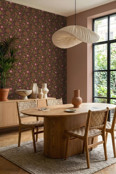 Helles Esszimmer mit floraler Vliestapete, ovalem Holztisch, geflochtenen Stühlen und großen Fenstern im modernen, organisierten Stil.