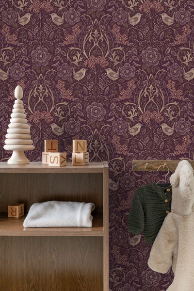 Kinderzimmer mit floraler Tapete, Holzregal und Kinderkleidung an der Wand.