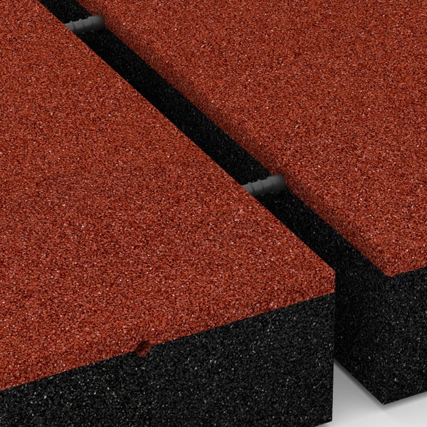 Detailansicht von roten und schwarzen Fallschutzmatten aus Gummigranulat mit einem Steckverbindungssystem.