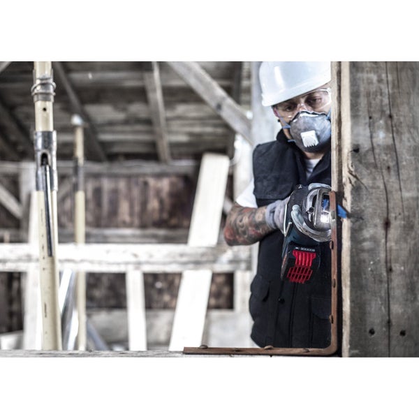Ein Handwerker mit Schutzhelm, Schutzbrille und Staubmaske arbeitet mit einer Akku-Blechschere an einem Holzrahmen.