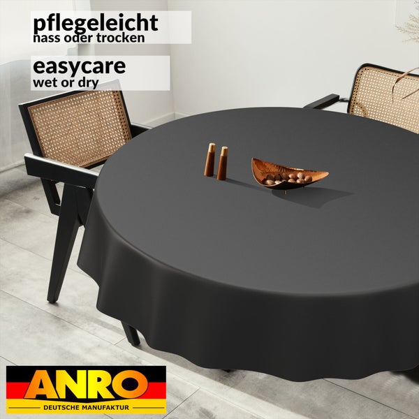 Runde anthrazitfarbene Tischdecke auf einem Esstisch, pflegeleichtes und abwischbares Material, ANRO Logo.