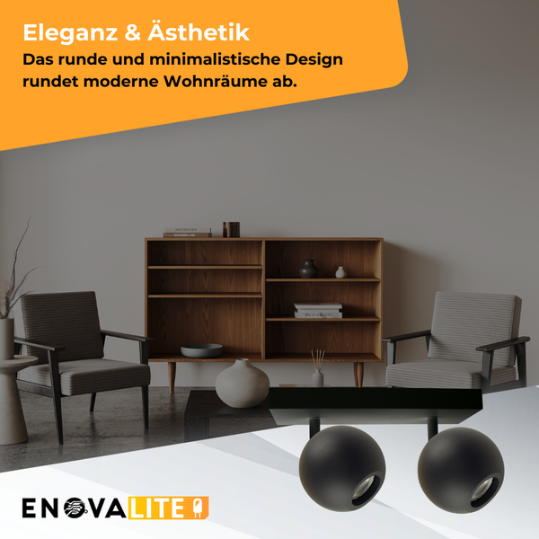 Zwei schwarze, runde Wandleuchten in einem modern eingerichteten Wohnraum.