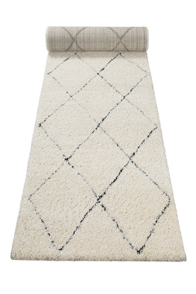 Hochflor-Läufer mit schwarzem Rautenmuster auf weißem Grund.