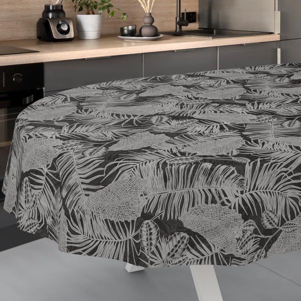 Runde Tischdecke mit Palmenblatt-Muster auf einem Tisch in einer modernen Küche.
