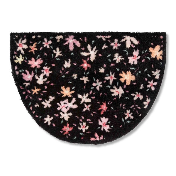 Halbrunde Fußmatte mit Blumenmuster auf dunklem Grund