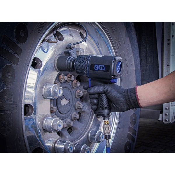 Eine Person benutzt einen Druckluft-Schlagschrauber der Marke BGS zum Wechseln eines Reifens