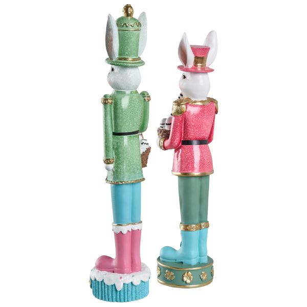 Zwei dekorative Hasenfiguren im Soldaten-Stil, bunte Osterdekoration aus Kunststein, stehend auf verzierten Sockeln.