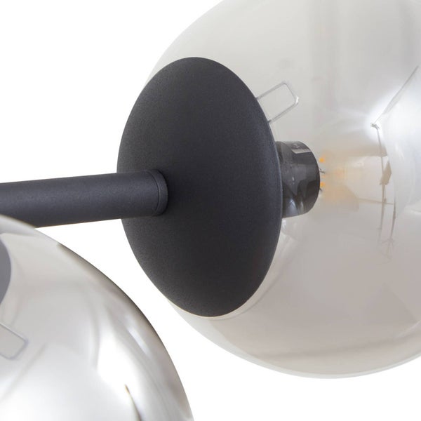 Detailansicht einer Deckenleuchte mit mehreren Glaskugeln und einem zentralen, schwarzen Befestigungselement.