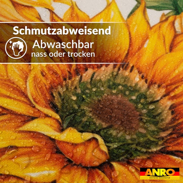 Wachstuch mit Sonnenblumen-Dekor, schmutzabweisend und nass oder trocken abwaschbar. Symbol für leichte Reinigung. ANRO Deutsche Manufaktur Logo.