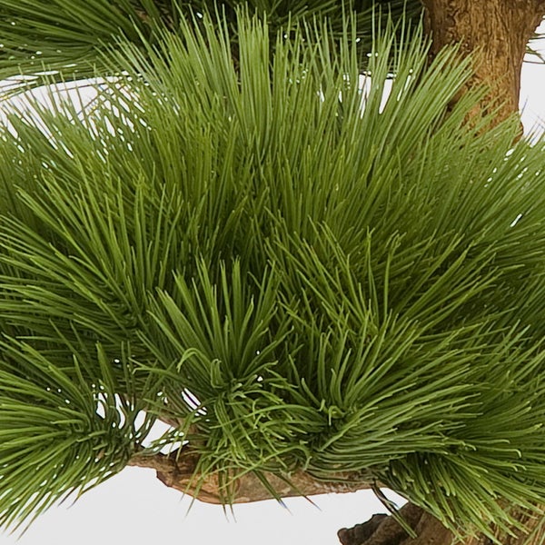 Künstlicher Kirschblütenzweig mit rosafarbenen Blüten und grünen Blättern.