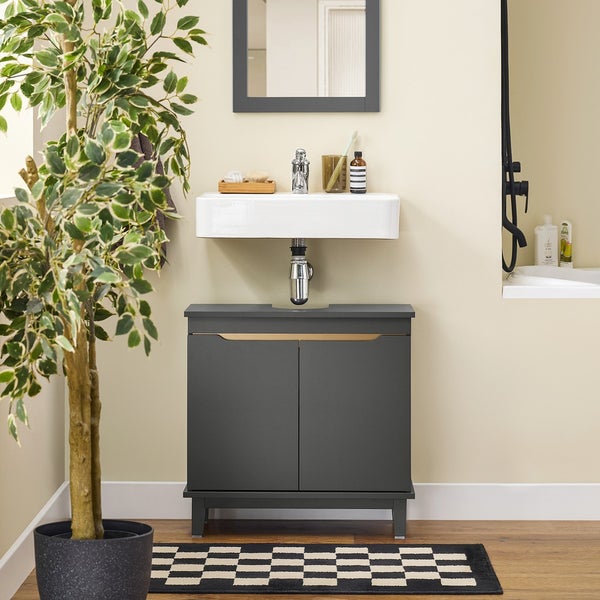 Badezimmer mit Waschbecken, Unterschrank, Spiegel und Zimmerpflanze