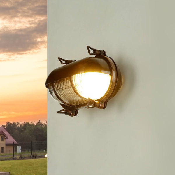 Beleuchtete Wandleuchte im maritimen Stil an einer Wand