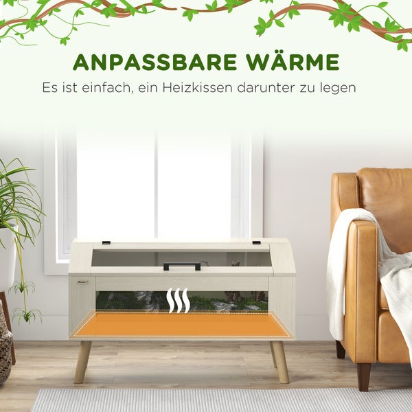 Holz-Terrarium für Schildkröten in einem hellen Wohnzimmer mit markierter Fläche für ein Heizkissen unter dem Boden zur Wärmeregulierung.