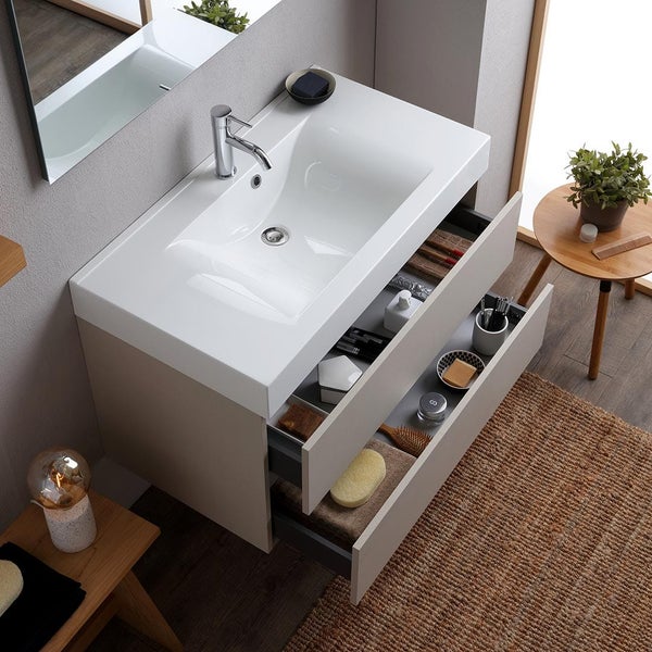 Badezimmer mit Waschtischunterschrank, Waschbecken, Armatur und offenen Schubladen