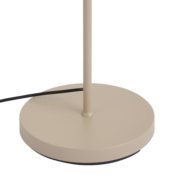 Runder Lampenfuß einer Stehleuchte mit Metallstange und schwarzem Netzkabel