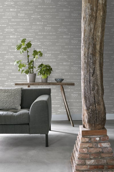 Wohnzimmer mit Sofa, Tisch, Zimmerpflanzen und gemusterter Tapete