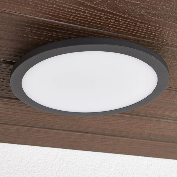 Rundes LED-Panel mit schwarzem Rahmen an einer Holzoberfläche.