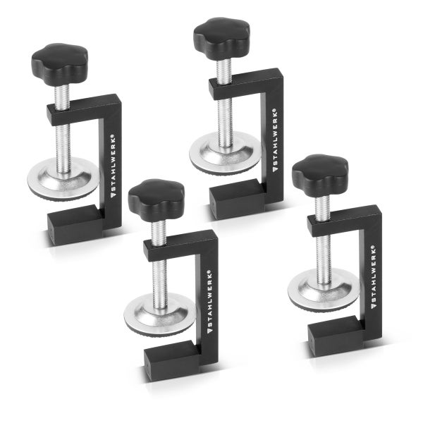 Set mit 4 Stahlwerk Schraubzwingen für Schweißtische aus Metall mit schwarzem Kunststoffgriff.