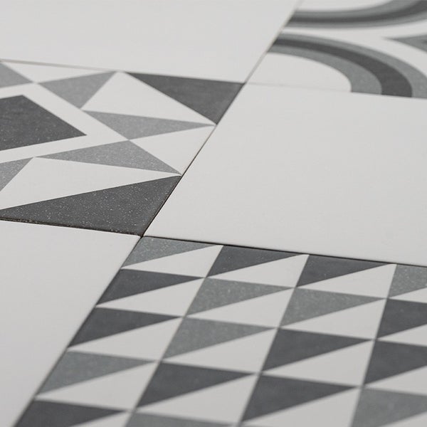 Quadratische Fliesen mit geometrischen Mustern und unifarbenen Flächen in einer modernen Kombination für Boden oder Wand
