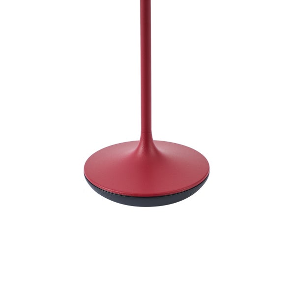 Runder Lampenfuß einer Stehleuchte mit Standrohr in Rot und Schwarz.