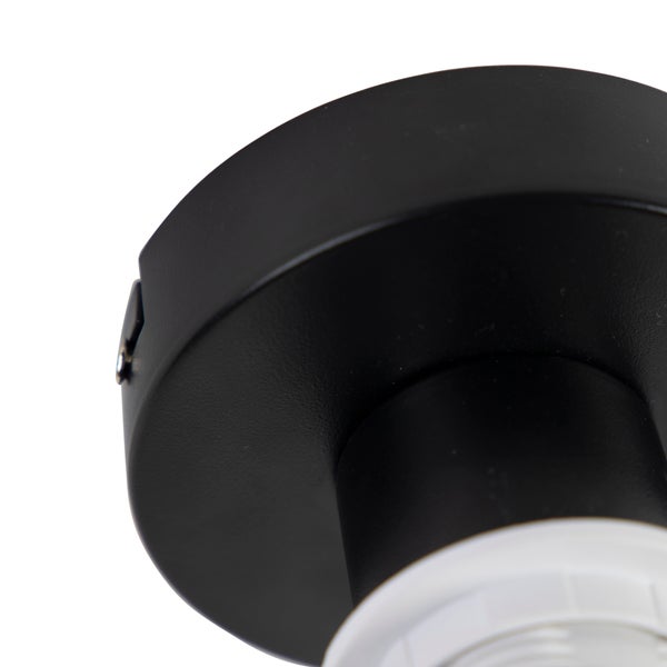 Schwarzer, matter Deckenanschluss einer Leuchte mit weißer Lampenfassung.