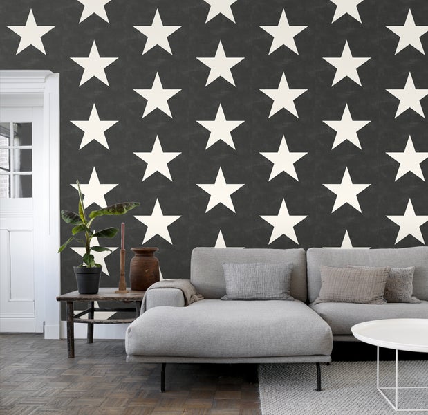 Wohnzimmer mit Sofa und Wandtapete mit Sternenmuster