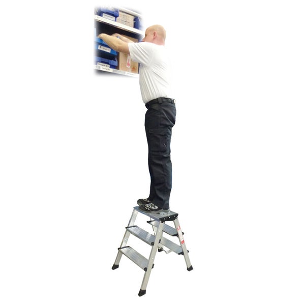 Mann steht auf Trittleiter und greift nach Waren im Regal