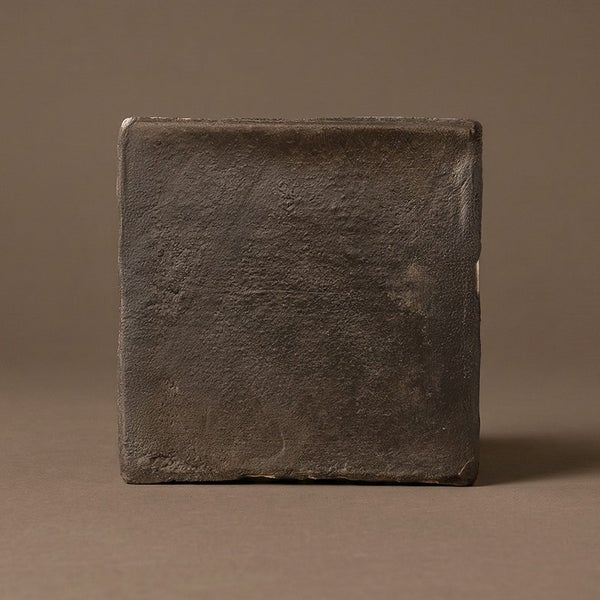 Quadratische Wandfliese mit strukturierter Oberfläche und unregelmäßigen Kanten im Landhausstil.