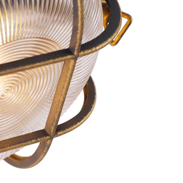 Detail einer Leuchte mit geriffeltem Glas und einem Metallkäfig im Industriedesign.