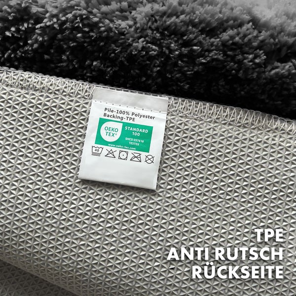 Detailansicht eines Teppichs mit Hinweisen zu Material und Pflege, inklusive Oeko-Tex Standard 100 Siegel und Informationen zur rutschfesten TPE-Rückseite